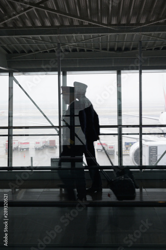 silhouette of pilots in airport