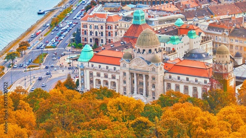 BUDAPEST, HUNGARY - OCTOBER 3, 2018: The famous Gellert Hotel Palace facade and entrance with Gellert Baths thermal spa at Gellert hill in Budapest, popular Europe travel destination. Aerial fall view photo