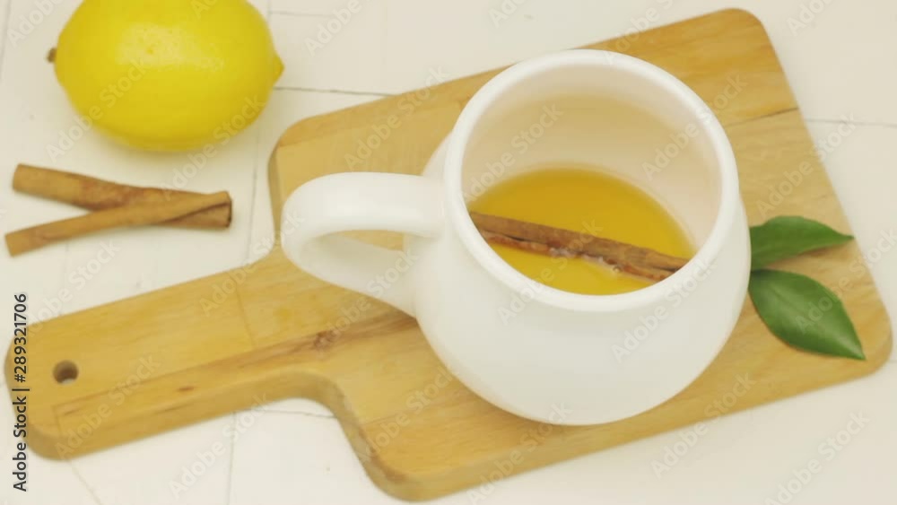 The Level Of Tea With Cinnamon And Lemon In The Cup Rises. Stop Motion Video The Level Of Tea With Cinnamon And Lemon In The Cup Rises. Stop Motion Video