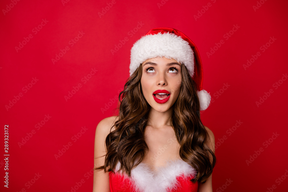 Close up photo of impressed lady staring up wearing stylish skirt dress isolated over red background Close up photo of impressed lady staring up wearing stylish skirt dress isolated over red background