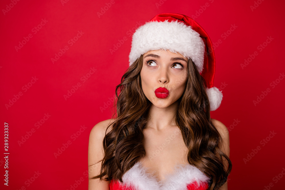 Close up photo of minded girl looking up having thought wearing skirt dress isolated over red background Close up photo of minded girl looking up having thought wearing skirt dress isolated over red background