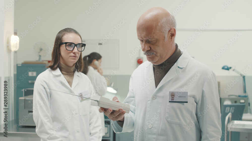 Retro style scientist receiving an important phone call Retro style scientist receiving an important phone call
