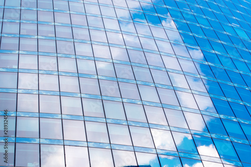 Close-up Windows on a glass office building with a reflection of the sky.