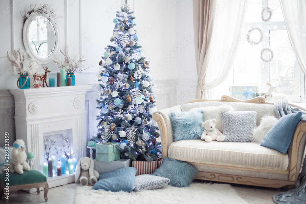 Christmas tree decorated with lovely ornaments and classical style fireplace in white room. New year scene. Christmas tree decorated with lovely ornaments and classical style fireplace in white room. New year scene.