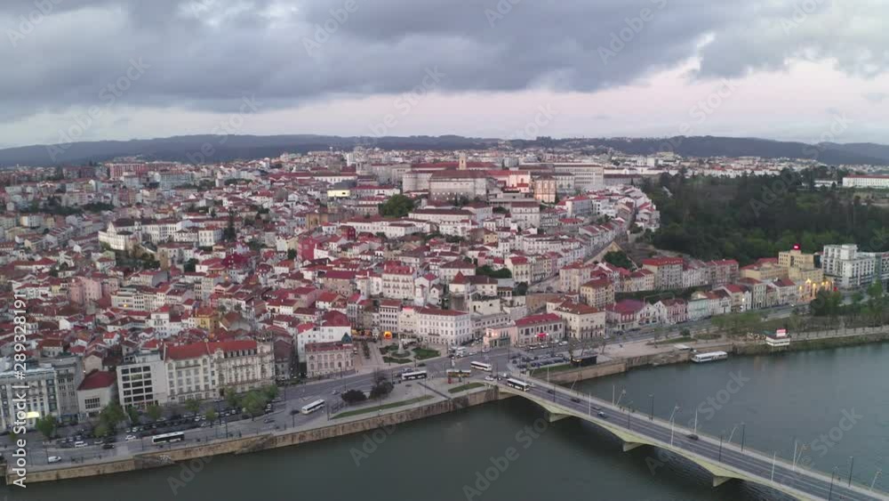 Aerial drone view of Coimbra city and Mondego river at sunset
