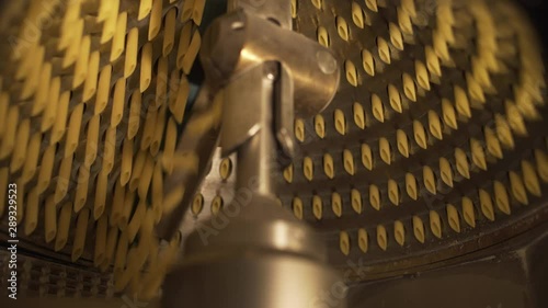 Suggestive shot of raw pasta rigatoni macaroni extruder in a pasta factory.