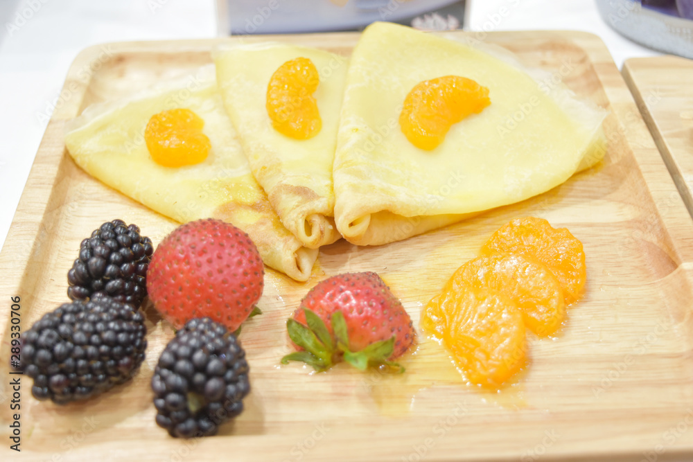 Fresh pancakes with strawberry, black berries and orange on wooden plate. Fresh pancakes with strawberry, black berries and orange on wooden plate.