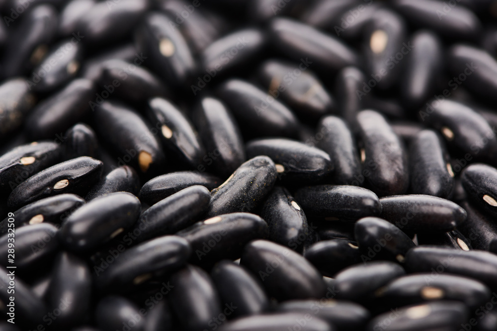 close up view of uncooked small black beans close up view of uncooked small black beans