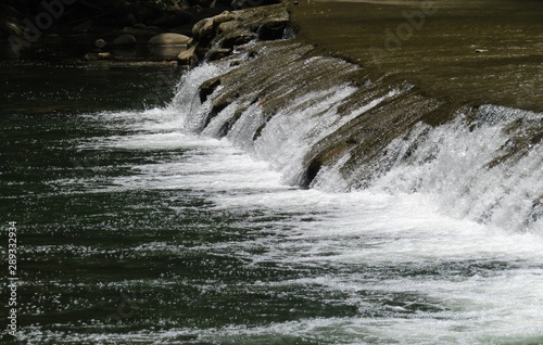 Fototapeta Naklejka Na Ścianę i Meble -  river dropping on rocks to a lower level