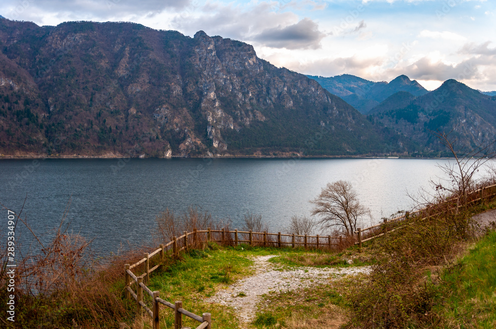 Panorama of Lake Idro from the town of Anfo, with a tourist and fishing port, a tourist destination for holidays at the lake, at the foot of the Alps immersed in unspoilt nature.