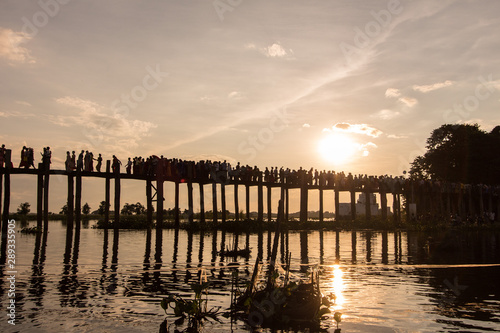 Sunset with silhouette of people walking  on Bridge U-Bein in the evening 