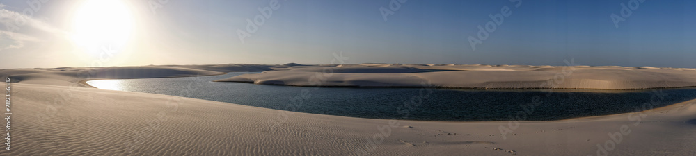 Lençois Maranhenses oasis lake in desert with sand dunes panoramic view