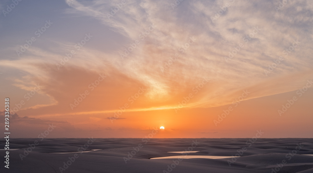 Lençois Maranhenses oasis lake in desert with sand dunes sunset view