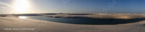 Lençois Maranhenses oasis lake in desert with sand dunes panoramic view