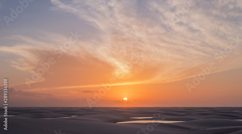 Lençois Maranhenses oasis lake in desert with sand dunes sunset view
