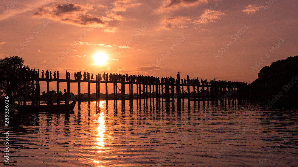 People walking on Bridge U-Bein at sunset scene