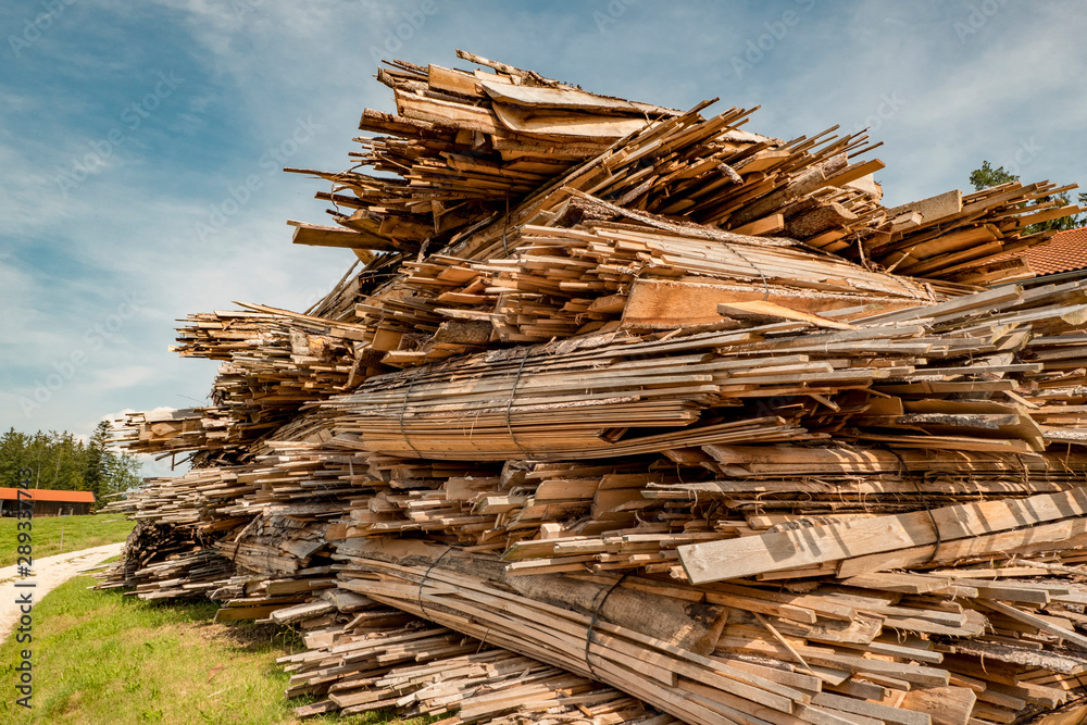 cut and stacked wood in planks cut on a meadow cut and stacked wood in planks cut on a meadow