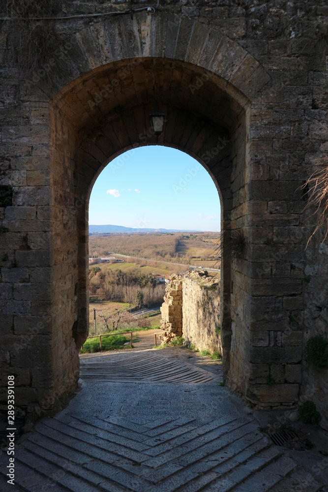 Beautiful view to the tuscany landscape through the gates of medieval town Monteriggioni, Tuscany, Italy