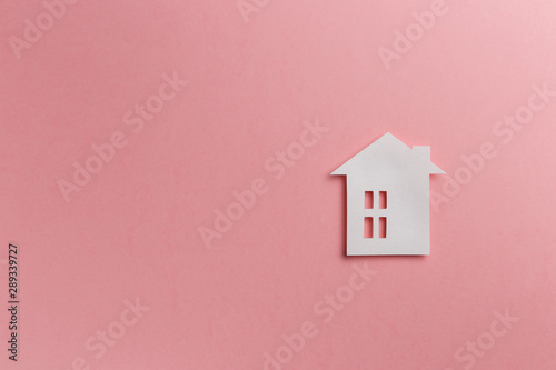 Minimalistic paper house on a pink background. Top view. Flat lay. Copy space. Colorful background. New minimal creative concept