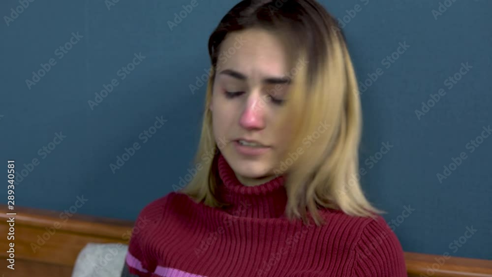 Young women sneezes. The girl lies on the bed under the plaid in a circle napkins are scattered. Acute Respiratory Viral Infection Young women sneezes. The girl lies on the bed under the plaid in a circle napkins are scattered. Acute Respiratory Viral Infection