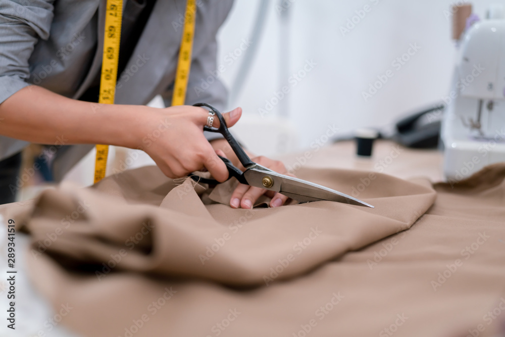 Female hands of designer at work with fabric close-up. Tailor measuring  necessary amount of material for sewing cloth. 18922564 Stock Photo at  Vecteezy