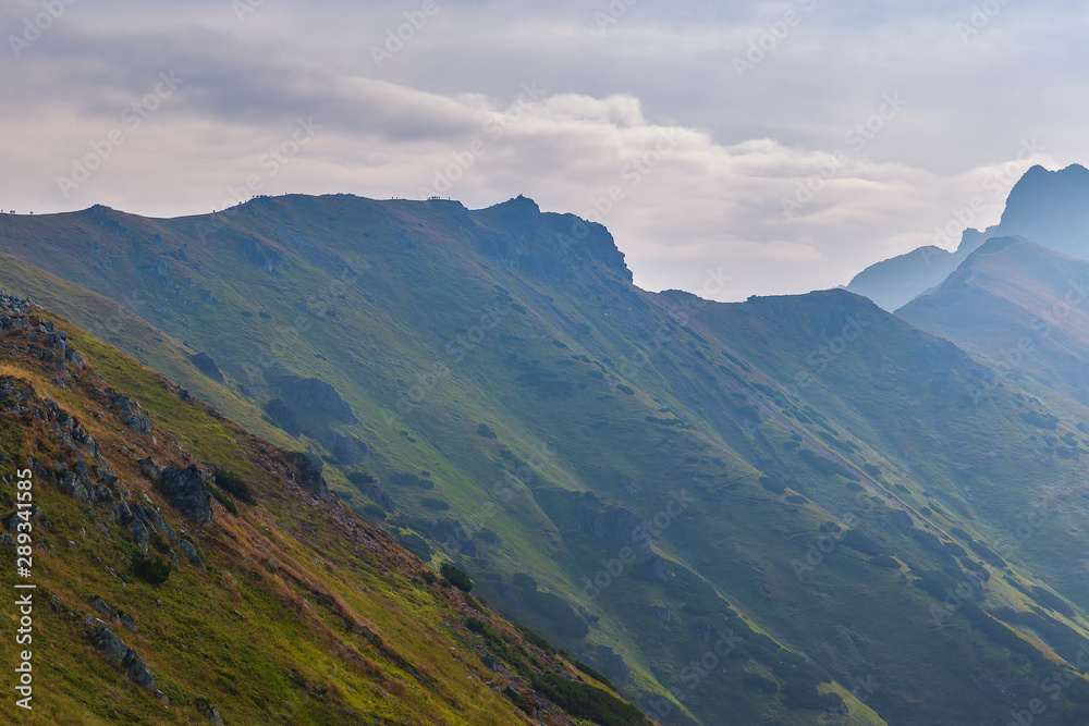 Tourists walking along the ridges of the mountains in the Tatras Tourists walking along the ridges of the mountains in the Tatras
