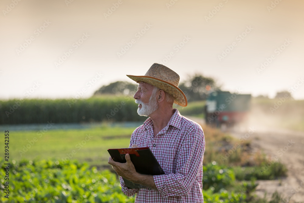 Farmer writing notes in field