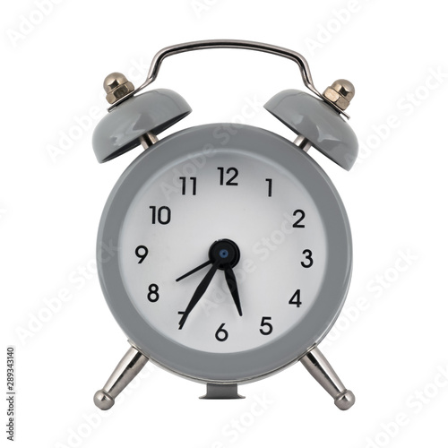 A gray clock with an alarm clock on a white background shows with arrows the time is five hours thirty five minutes or seventeen hours thirty five minutes