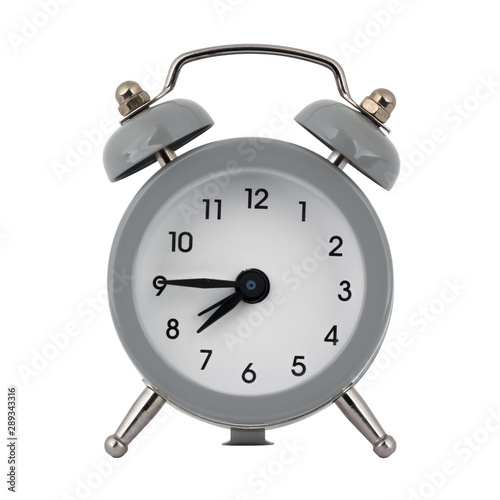 A gray clock with an alarm clock on a white background with arrows showing the time seven hours forty five minutes or nineteen hours forty five minutes