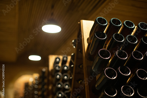 winery with wine bottles and wooden barrel