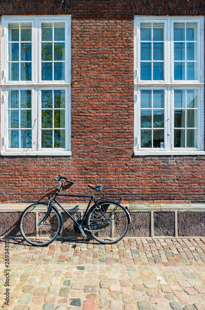 Exterior architecture. Vintage bicycles in front of brick facace in Copenhagen, Denmark