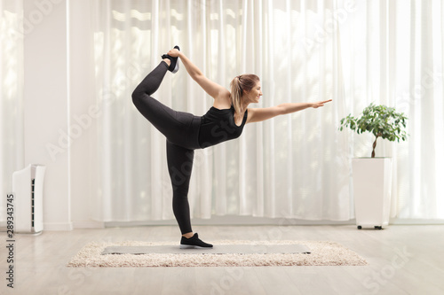 Young woman doing pilates pose at home