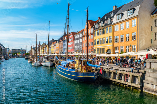 View of Nyhavn pier with color buildings, ships, yachts and other boats in the Old Town of Copenhagen, Denmark