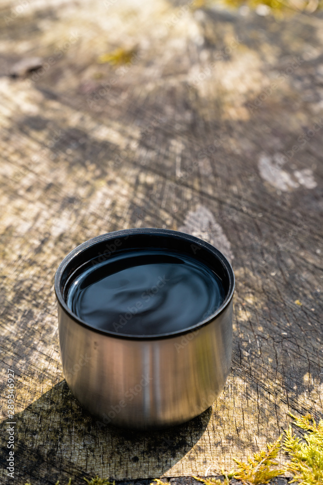 Warm beverage in the woods - closeup Warm beverage in the woods - closeup
