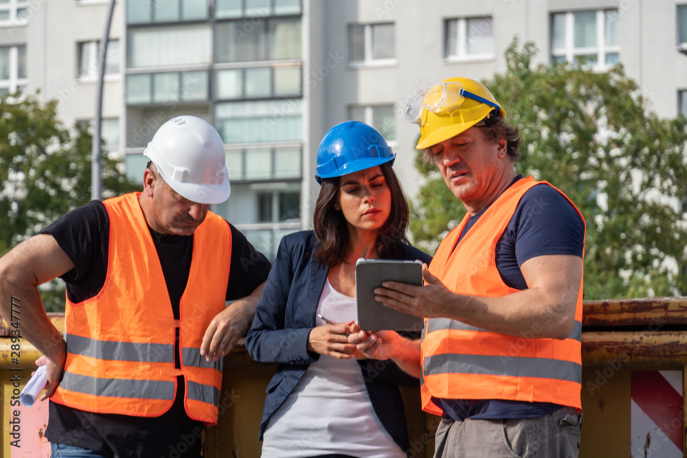 Group of male and female workers on construction site Group of male and female workers on construction site
