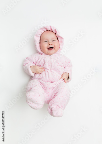 Cute baby dressed in warm overall for winter cold weather.