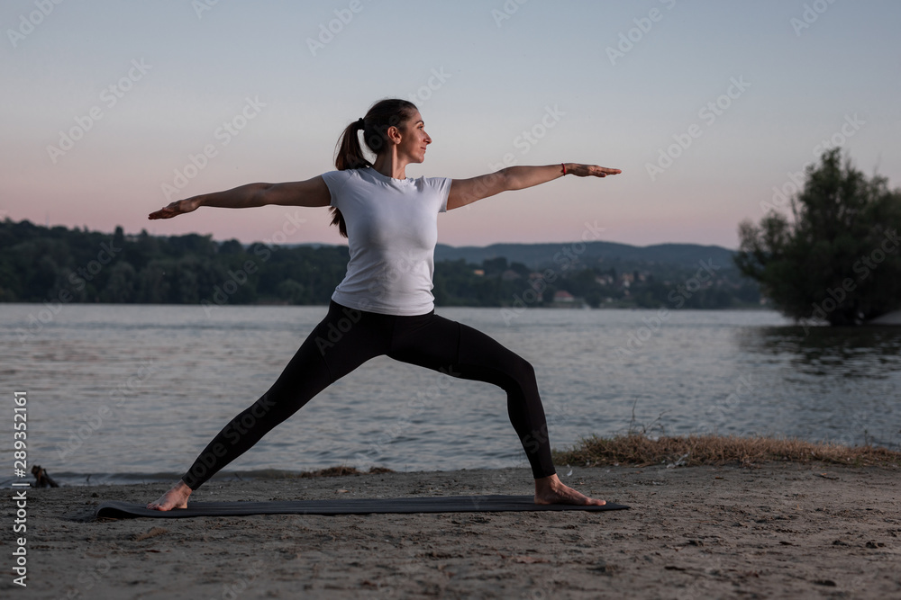 Beautiful young woman is practicing yoga in the nature Beautiful young woman is practicing yoga in the nature