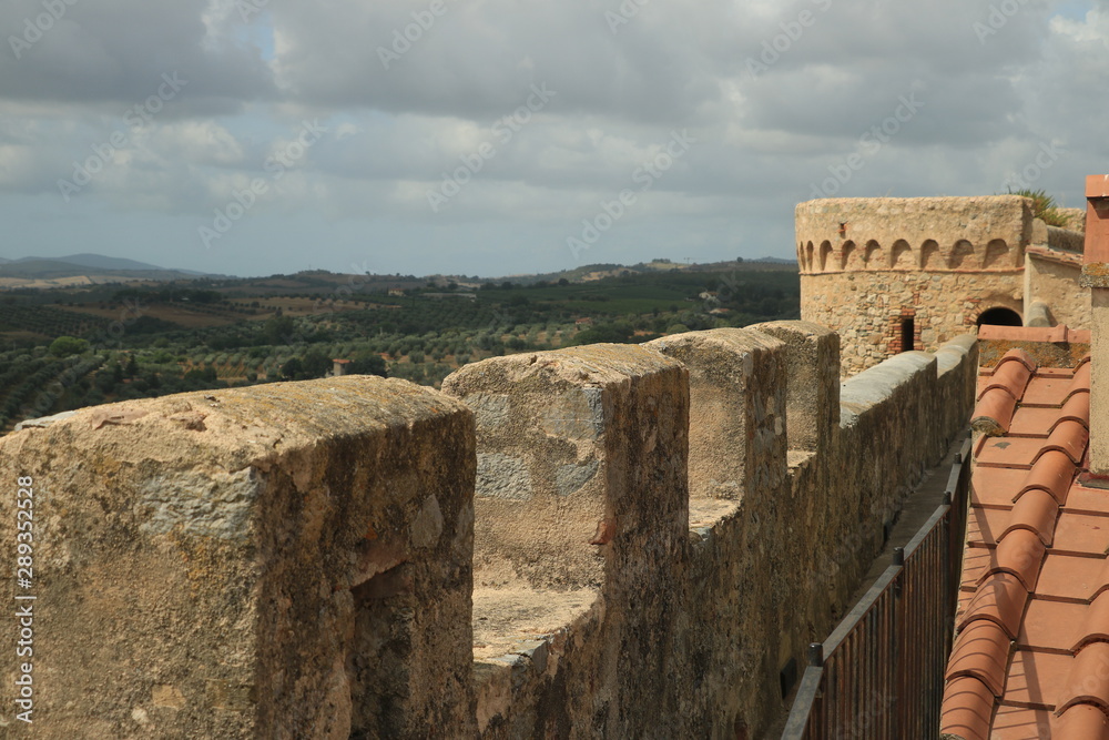 Walls of the town of Magliano in Tuscany. Maremma. .Path on the castle walls. Landscape with countryside of the hills..