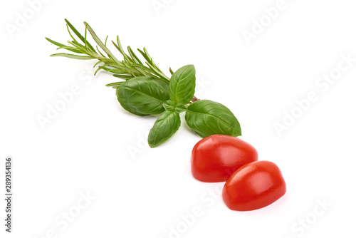 Fresh organic basil leaves with tomato slices, isolated on white background