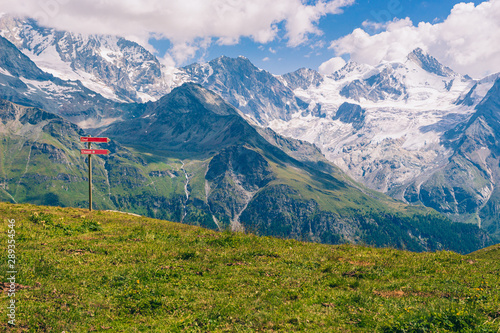 Spectacular view on high snowy peaks of the Pennine Alps under cloudy sky seen from Sorebois in the summer. Zinal, Val d' Anniviers, Valais, Switzerland