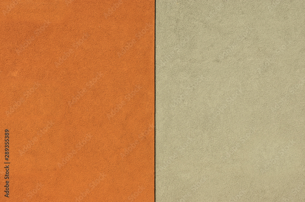 Fototapeta premium Ausschnitt Fassade zweifarbiger Putz in Beige und orange mit schwarzer vertikaler Trennlinie in verschiedenen Aufteilungen