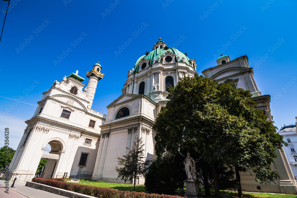 Karlskirche catholic church in white stone with turquoise domes. Cathedral in Vienna. Bottom view