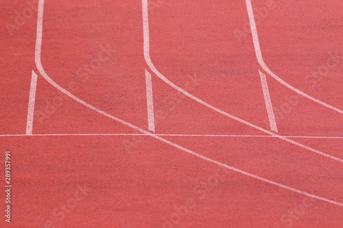Stadium sport background with copy space. Running track with special cover in pink color for training. © Garmon
