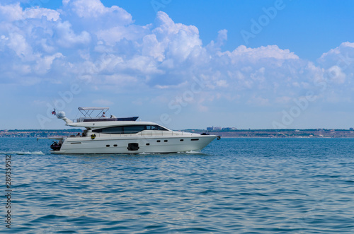 Small yacht in motion on the sea during the summer season © zyoma_1986