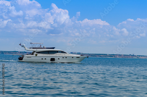 Small yacht in motion on the sea during the summer season
