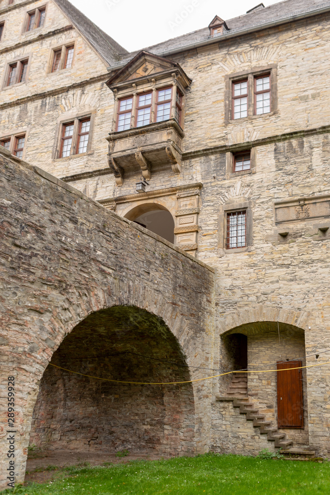 Architectural detail of the Wewelsburg castle with brick construction, hidden staircase and door on the canal level and main entrance portal above Architectural detail of the Wewelsburg castle with brick construction, hidden staircase and door on the canal level and main entrance portal above