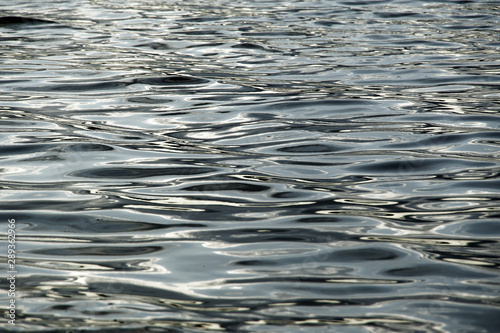 wave pattern on the water, refelecting light and shadows, real picture