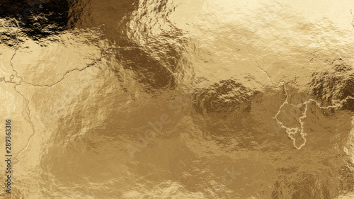 Shiny wrinkled golden foil texture. Crumpled metal background. photo