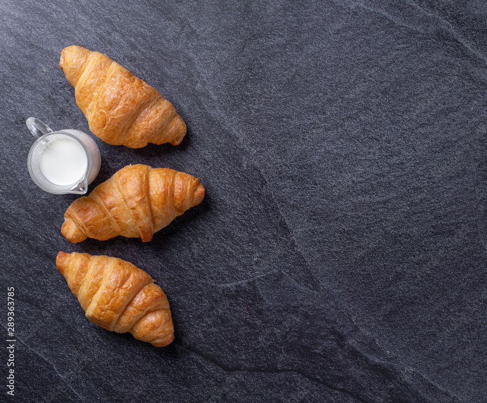 Fresh croissants on a black slate background. Top view Copy space Fresh croissants on a black slate background. Top view Copy space