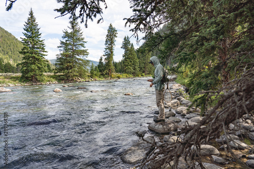 Fly fisher on the Gallatin River in Big Sky, Montana photo